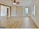 Spacious living room with wood-style floors and natural light is perfect for entertaining at 435 Crabapple Rd, Fayetteville, GA 30215
