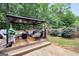 Backyard featuring wooden deck with covered gazebo, patio furniture, and green landscaping at 422 Old Ivy Path, Mcdonough, GA 30253