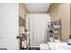 Neutral bathroom featuring shower with curtain and shelving for storage at 422 Old Ivy Path, Mcdonough, GA 30253