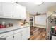 Kitchen featuring updated appliances, laminate countertops, and wood floors at 422 Old Ivy Path, Mcdonough, GA 30253
