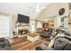 Inviting living room with vaulted ceilings, brick fireplace, and cozy, oversized sectional sofa at 422 Old Ivy Path, Mcdonough, GA 30253