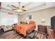 Cozy main bedroom with tray ceilings, dark hardwood floors, and comfortable queen bed at 422 Old Ivy Path, Mcdonough, GA 30253