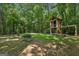 Spacious backyard featuring mature trees and a custom-built treehouse for Gathering fun at 230 Vienna Way, Douglasville, GA 30134