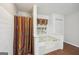 Bathroom featuring a soaking tub with curtained shower and a window with decorative curtain at 230 Vienna Way, Douglasville, GA 30134