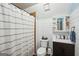 This cozy bathroom features a shower with curtain, vanity, and toilet with white shiplap walls at 230 Vienna Way, Douglasville, GA 30134