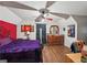 Charming bedroom with desk, featuring a dresser, hardwood floors, and a ceiling fan at 230 Vienna Way, Douglasville, GA 30134