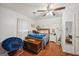 Bright bedroom with hardwood floors, a comfortable bed, and a cozy reading chair creating a relaxing retreat at 230 Vienna Way, Douglasville, GA 30134
