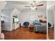 Cozy bedroom featuring wood floors, ceiling fan, and wall-mounted television on dresser at 230 Vienna Way, Douglasville, GA 30134