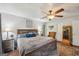 This bedroom features a large bed frame, a ceiling fan, and hardwood flooring with a rug at 230 Vienna Way, Douglasville, GA 30134