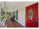 Inviting front porch with rocking chairs and a vibrant red front door at 230 Vienna Way, Douglasville, GA 30134