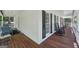 Wrap around porch of home with white siding, dark shutters, and rocking chairs at 230 Vienna Way, Douglasville, GA 30134