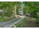 Charming home with a long driveway surrounded by mature trees and ample parking spaces at 230 Vienna Way, Douglasville, GA 30134