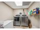 Laundry room with modern washer and dryer units at 230 Vienna Way, Douglasville, GA 30134