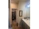 Bathroom with a vanity, framed mirror, and walk in closet for optimal storage and convenience at 2635 Lovejoy Crossing Ln, Hampton, GA 30228