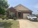 Charming one-story brick home with well-manicured lawn and inviting curb appeal on a sunny day at 2635 Lovejoy Crossing Ln, Hampton, GA 30228
