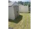 Durable backyard storage shed for gardening tools and equipment, nestled beside a privacy fence at 2635 Lovejoy Crossing Ln, Hampton, GA 30228