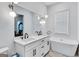 Bright bathroom featuring double sinks, large mirror, and freestanding tub at 3587 Candler Ct, Hapeville, GA 30354