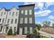 Modern three-story home with a combination of white and gray exterior and large windows at 3587 Candler Ct, Hapeville, GA 30354
