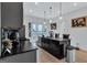 Stylish kitchen featuring a large island with dark countertops, a wine rack, stainless steel appliances, and an open layout at 3587 Candler Ct, Hapeville, GA 30354
