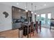 Modern kitchen with gray cabinets, stainless steel appliances, and a large island with bar seating and pendant lighting at 3587 Candler Ct, Hapeville, GA 30354