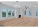 Bright, open living room with wood floors, a fireplace, and modern lighting at 3587 Candler Ct, Hapeville, GA 30354