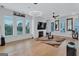 Open living room with wood floors, fireplace, and large windows at 3587 Candler Ct, Hapeville, GA 30354