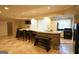 Stone clad basement bar with bar seating, sink and an appliance package at 1010 Forest Overlook Sw Dr, Atlanta, GA 30331