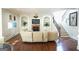 Bright living room with fireplace, built-in shelving, hardwood floors, and staircase at 1010 Forest Overlook Sw Dr, Atlanta, GA 30331