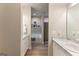 View down a long bathroom with matching marble vanities on either side, and a soaker tub with decorative shelves at 344 Dylan Way, Mcdonough, GA 30252
