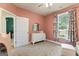 Calming Bedroom with soft pink walls and white furniture at 344 Dylan Way, Mcdonough, GA 30252