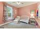 Charming Bedroom with a crib and a floral-patterned curtain at 344 Dylan Way, Mcdonough, GA 30252
