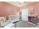 Pretty Bedroom with pink accents and comfortable armchair at 344 Dylan Way, Mcdonough, GA 30252
