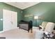 Bedroom with neutral rocking chair, black crib, custom dark-green paint, and plenty of natural light at 344 Dylan Way, Mcdonough, GA 30252