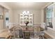 Elegant dining room with a wooden table, white chairs, and a classic china cabinet, perfect for gatherings at 344 Dylan Way, Mcdonough, GA 30252