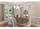 Charming dining room with a wood table, white chairs, and ample natural light, creating a welcoming space at 344 Dylan Way, Mcdonough, GA 30252