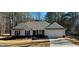 Charming single-story home with gray siding, black shutters, and a well-manicured front yard at 344 Dylan Way, Mcdonough, GA 30252