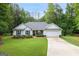 Inviting single-story home with lush green lawn, stone accents, and a convenient two-car garage, perfect for Gathering living at 344 Dylan Way, Mcdonough, GA 30252
