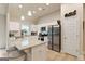 Bright kitchen features white cabinets, stainless appliances, granite counters, bar seating and recessed lighting at 344 Dylan Way, Mcdonough, GA 30252