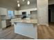 Bright kitchen with white cabinets, stainless steel appliances, granite countertops and an island at 344 Dylan Way, Mcdonough, GA 30252
