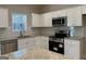 Modern kitchen featuring white cabinets, stainless steel appliances, and granite countertops at 344 Dylan Way, Mcdonough, GA 30252