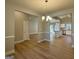 Open-concept living area featuring hardwood floors, neutral walls, and chandelier at 344 Dylan Way, Mcdonough, GA 30252