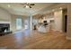 Open-concept living area featuring hardwood floors, a stone fireplace, and neutral walls at 344 Dylan Way, Mcdonough, GA 30252