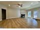 Bright and airy living area featuring hardwood floors, a stone fireplace, and access to outdoor space at 344 Dylan Way, Mcdonough, GA 30252