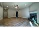 Large living area featuring hardwood floors, stone fireplace and neutral walls at 344 Dylan Way, Mcdonough, GA 30252