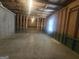 Unfinished basement features exposed beams and foundation, offering potential for customization at 7253 Lacey Dr, Douglasville, GA 30134