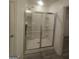 Bathroom showcases a glass enclosed shower with built-in shelving and tile flooring at 7253 Lacey Dr, Douglasville, GA 30134