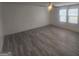 Neutral primary bedroom with ceiling fan, gray wood-look flooring, and bright natural light at 7253 Lacey Dr, Douglasville, GA 30134