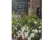 Stone entrance to Ashley Falls community with blooming flowers at 7253 Lacey Dr, Douglasville, GA 30134