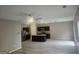 Open-concept kitchen featuring dark cabinets, a granite island, and stainless steel appliances at 7253 Lacey Dr, Douglasville, GA 30134