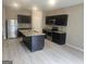 Kitchen with stainless steel appliances, grey vinyl floors, and dark cabinets at 7253 Lacey Dr, Douglasville, GA 30134
